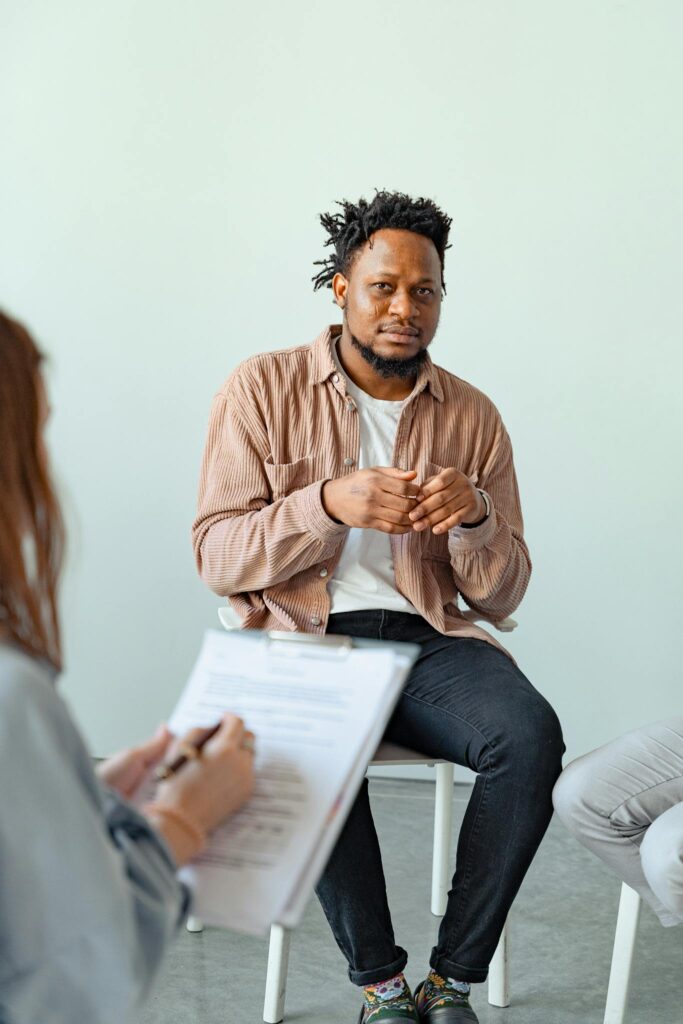 Therapist and client engaged in a counseling session to discuss mental health.