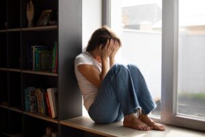 portrait young woman with low self esteem sitting by window home 23 2150038987